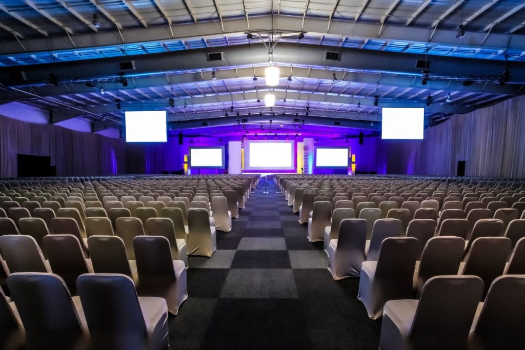 Many rows of empty chairs in the large conference hall for corporate convention or lecture