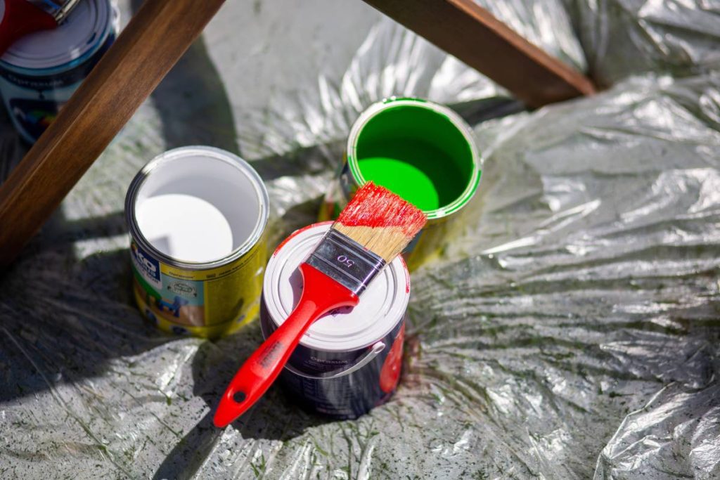 A high angle shot of paint and brushes on a construction site